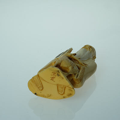 Japanese Stained Ivory Okimono of a Sage and Deer