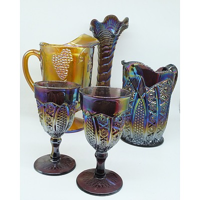 Group of Carnival Glass Including Two Water Pitchers, Two Goblets and a Vase