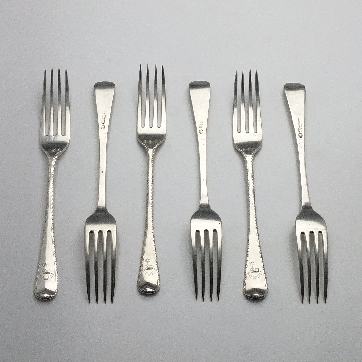 'Six George III Crested Sterling Silver Bright Cut Entree Forks London 1816 and 1817'
