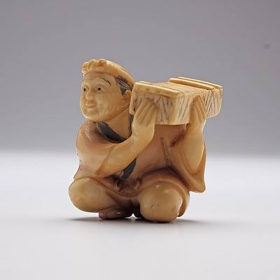 Japanese Carved Ivory Netsuke of a Man Holding a Box