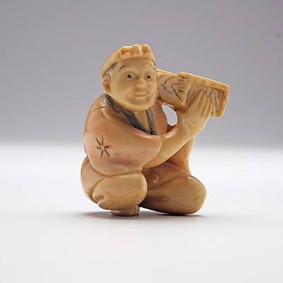Japanese Carved Ivory Netsuke of a Man Holding a Box