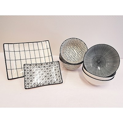 A selection of black and white bowls and platters