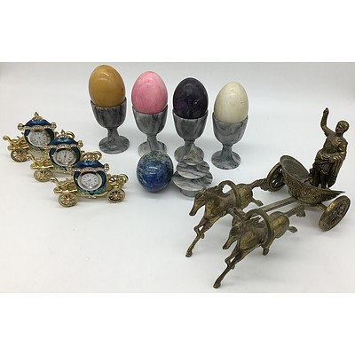 Collection of Decorative Ornaments, Including Eggs, Quartz Carriage Clocks, and Brass Julius Caesar Figure Riding on a Chariot