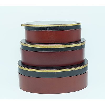 Three Graduating Oval Shaped Boxes in Black, Gold and Maroon