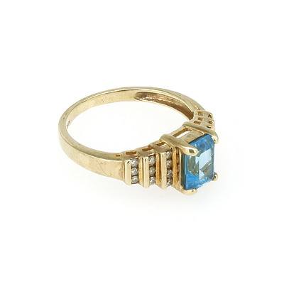 9ct Yellow Gold Ring with Emerald Cut Blue Topaz and Twenty Round Brilliant Cut Diamonds