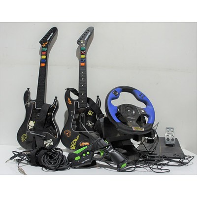 Two Guitar Hero Guitar Controllers, 4Gamers Gun Controller, Logitec Driving Force Steering Wheel Controller, Lot of Nine PS2 Games, and Three TS Cables