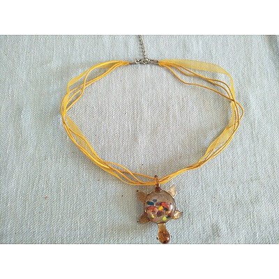 Glass turtle pendant on yellow ribbon necklace