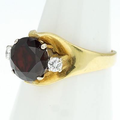18ct Yellow Gold Ring With Round Dark Red Garnet with a Round Brilliant Cut Diamond Each Side
