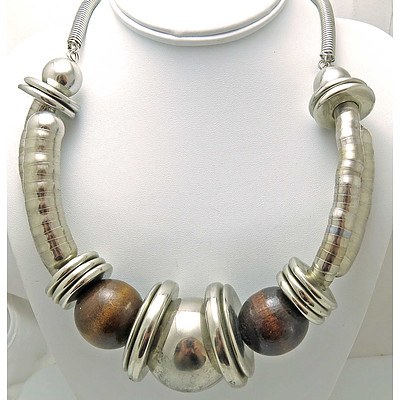 Dramatic designer necklace - silver tone with wooden beads.