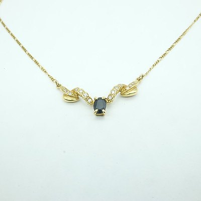 18ct Yellow Gold Fine Curb Link Chain with at Center Oval Dark Blue Sapphire and 14 Round Brilliant Cut Diamonds