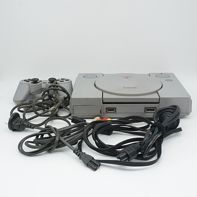 Original Playstation, Four Controllers, Ten Games Including Lara Croft Tomb Raider I, II, II, and The Last Revelation, and Cords