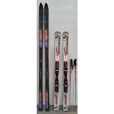 Two Sets of Snow Skis and Two Poles