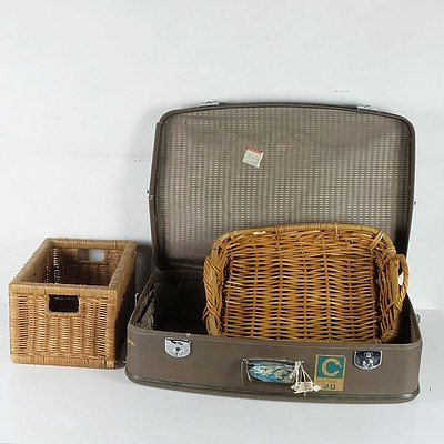 A Group of Cane Baskets and a Vintage Suitcase, Including a Large Group of Table Cloths and More 