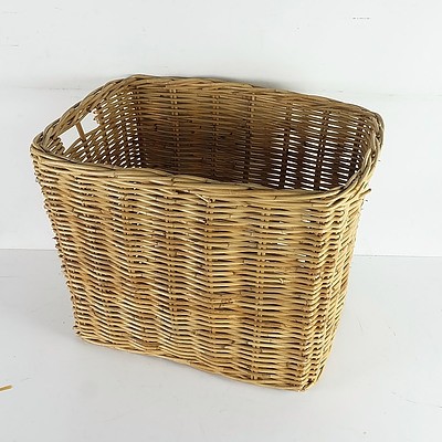 A Group of Cane Baskets and a Vintage Suitcase, Including a Large Group of Table Cloths and More 