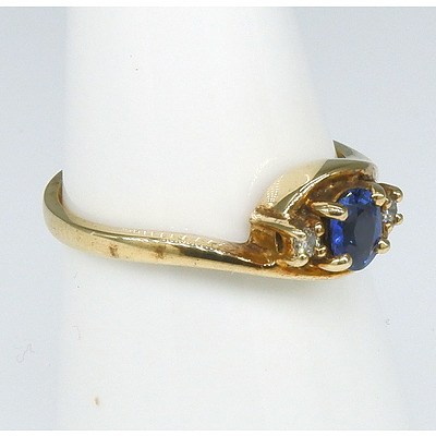 9ct Yellow Gold Ring with Oval Faceted Medium Blue Sapphire and Two Round Brilliant Cut Diamonds