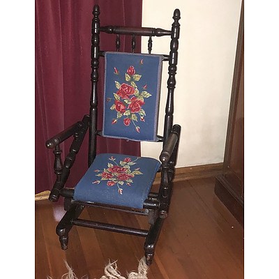 An Antique Ebonized Oak Rocking Chair with Tapestry Upholstery