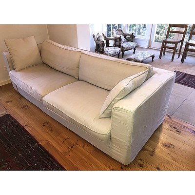 A Contemporary Linen Slip Covered Three Seater Sofa