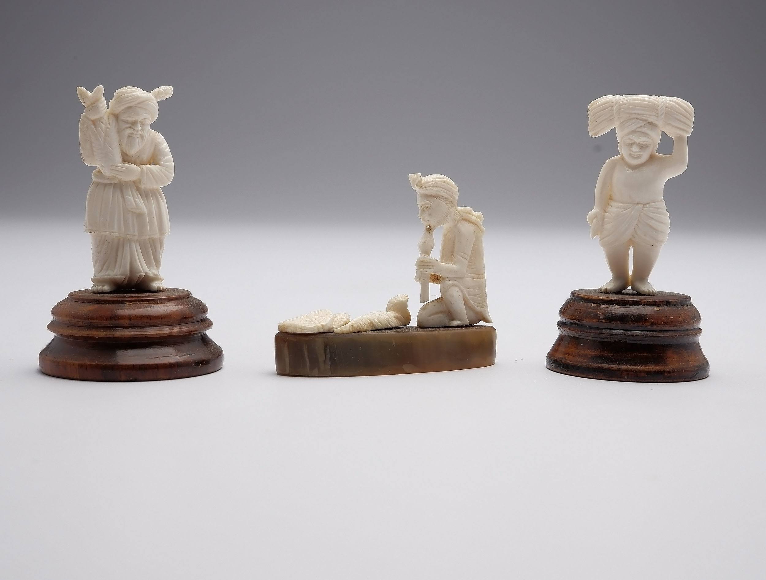 'Three Carved Indian Ivory Figures Including a Snake Charmer, Early to Mid 20th Century'