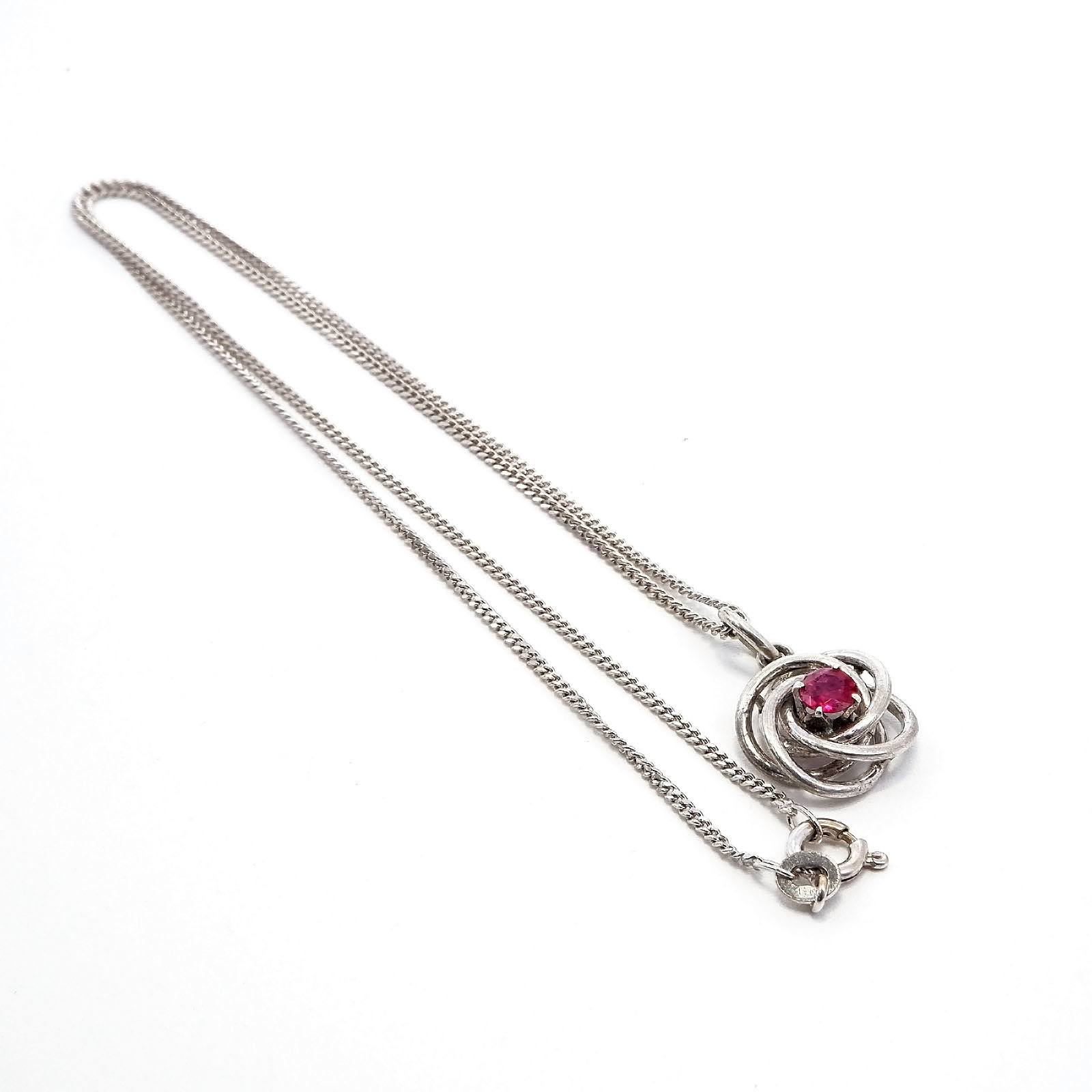 '18ct White Gold Pendant, Swirl Design with Brown Facetted Ruby on a Fine Filed Curb Link Chain, 4.3'