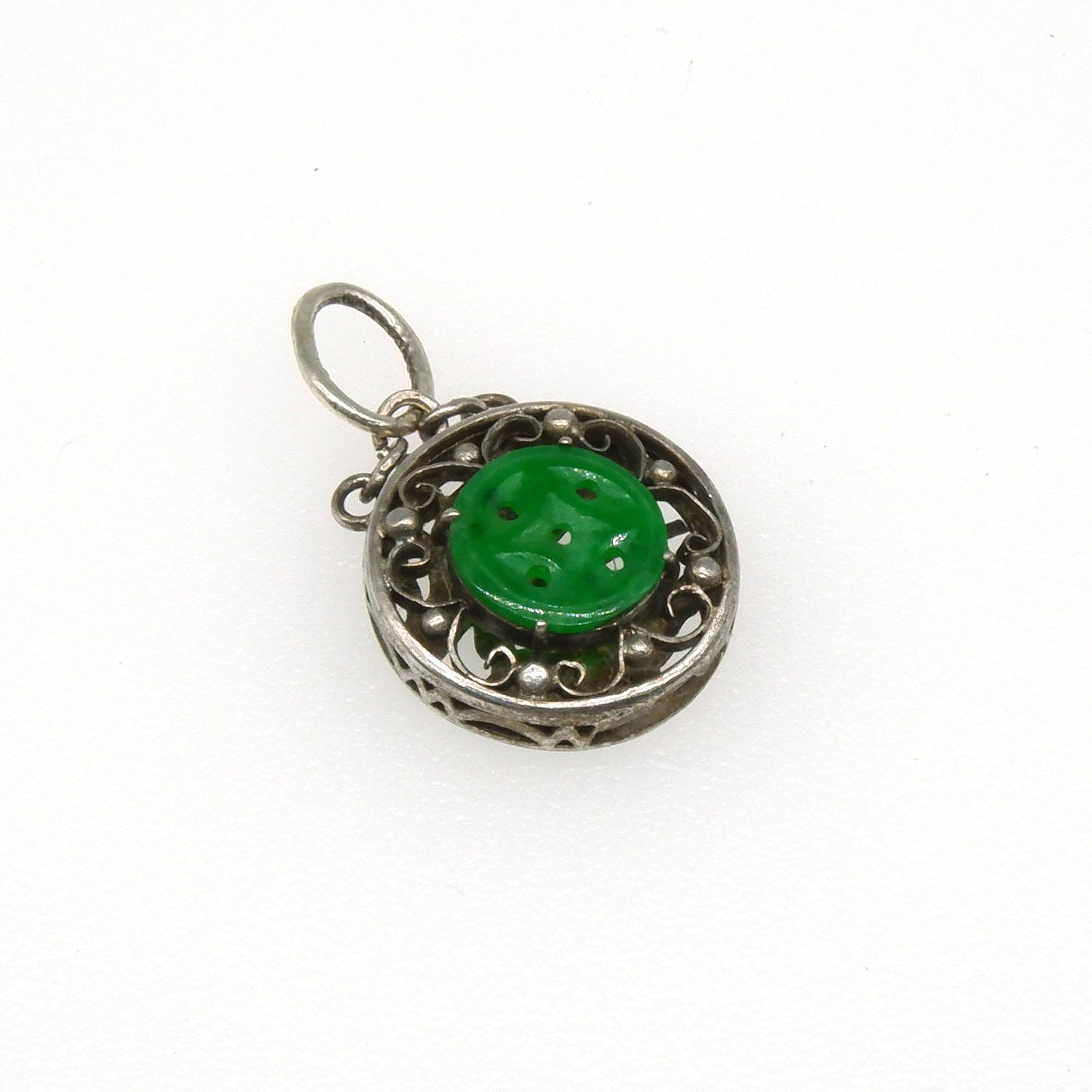 '14ct White Gold Round Fancy Box Pendant with Engraved Finish with Centre of Flat Button of Carved Jadeite on a Silver Scroll Chain'