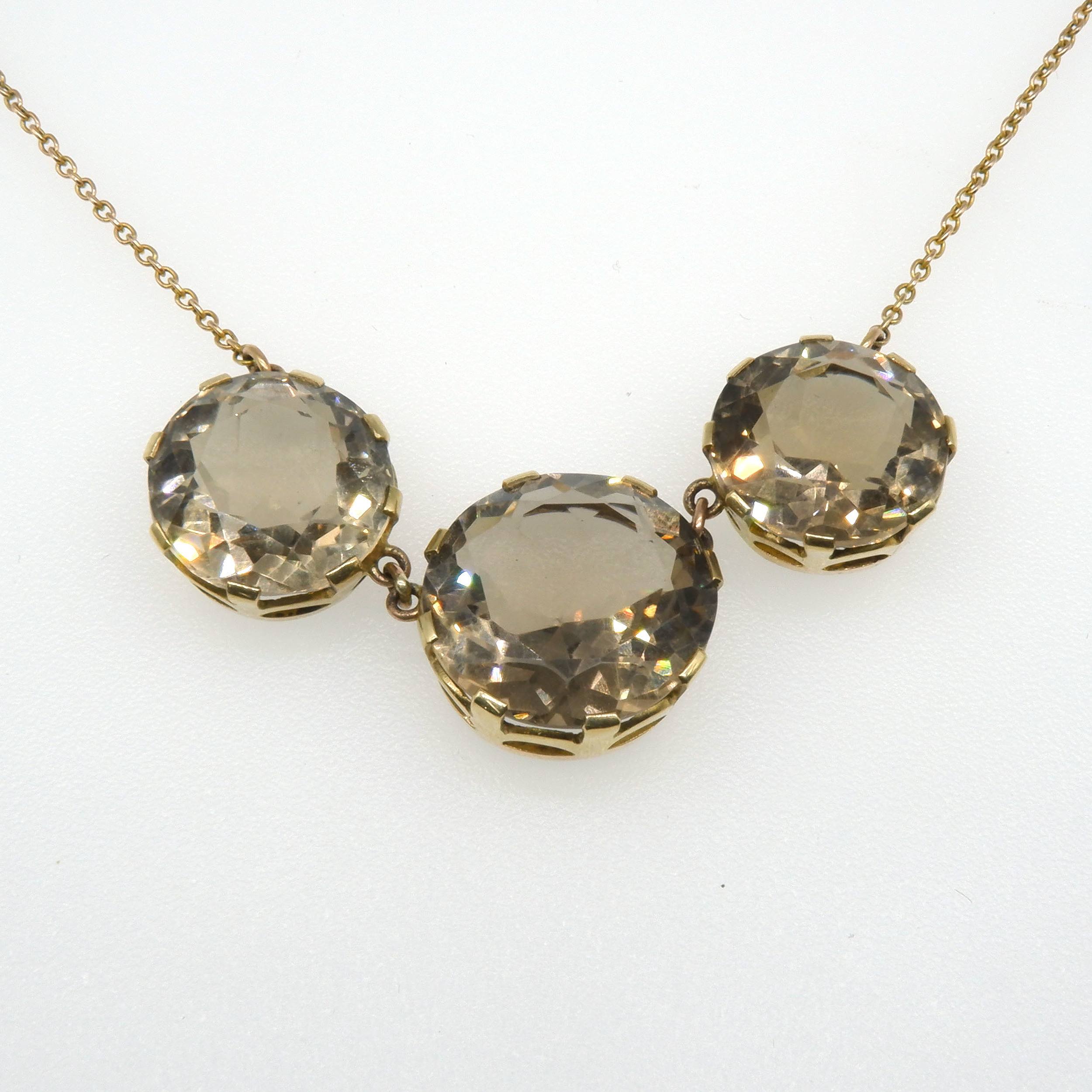 '9ct Yellow Gold with Three Round Facetted Smokey Quartz in Multi Claw Gallery Settings on Fine Chain'