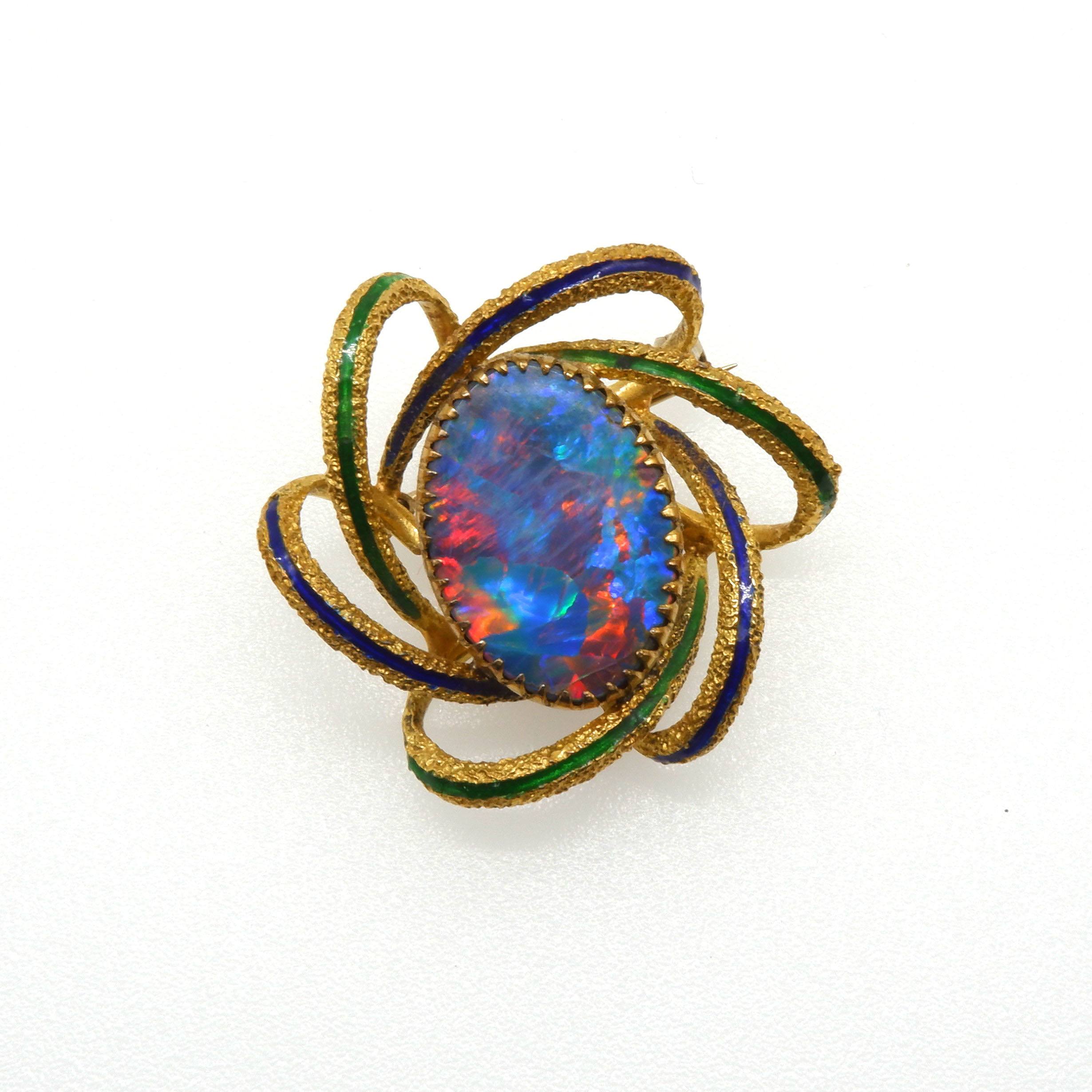'18ct Yellow Gold Black Opal Doublet Brooch with Excellent Play of Colour and Six Gold Wire Swirls with Blue and Green Enamelling Forming a Frame'