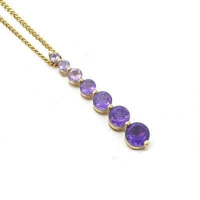 9ct Yellow Gold Pendant with a Drop of Graduated Amethysts in Colour and Size on a Gold Plated Chain
