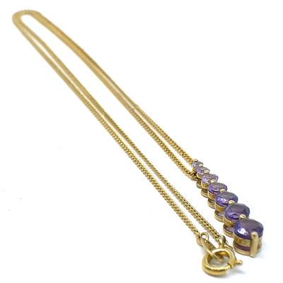 9ct Yellow Gold Pendant with a Drop of Graduated Amethysts in Colour and Size on a Gold Plated Chain