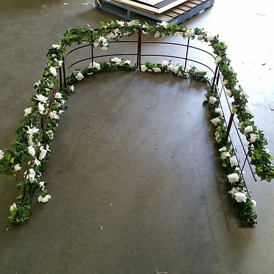 Floral and Wreath Covered Metal Arbor