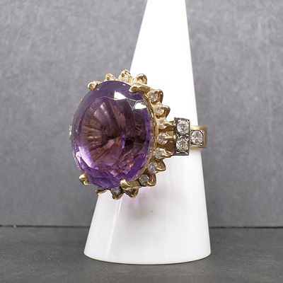 14ct Yellow Gold Ring with Large Oval Cut Amethyst and Thirty Two Round Brilliant Cut Diamonds Surround