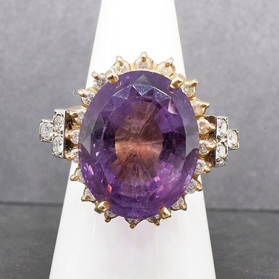 14ct Yellow Gold Ring with Large Oval Cut Amethyst and Thirty Two Round Brilliant Cut Diamonds Surround