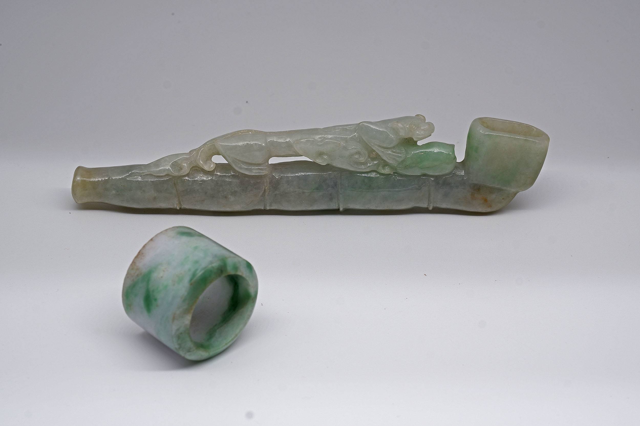 'Chinese Pale Apple Green Jadeite Chilong Pipe and an Archers Ring, Late Qing or Republic Period'