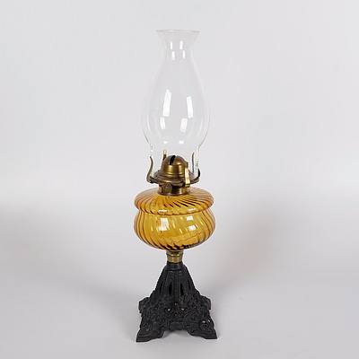 Table Oil Lamp with Amber Swirl Ribbed Glass Font and Decorative Cast Iron Base