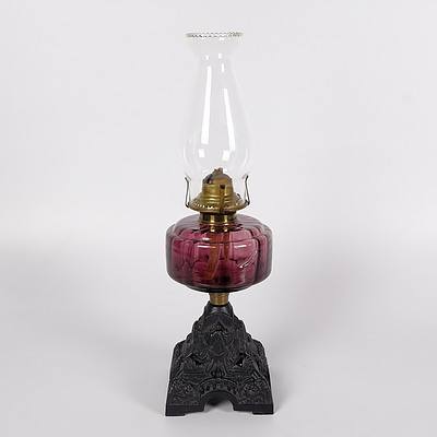 Table Oil Lamp with Cranberry Glass Font and Decorative Cast Iron Base