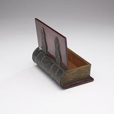 A Metal and Plastic Box in the Form of an Antique Book
