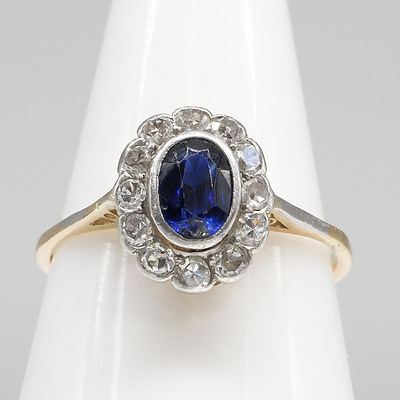 18ct Yellow and White Gold Ring with Oval Facietted Royal Blue Natural Sapphire and Twelve Single Cut Diamonds