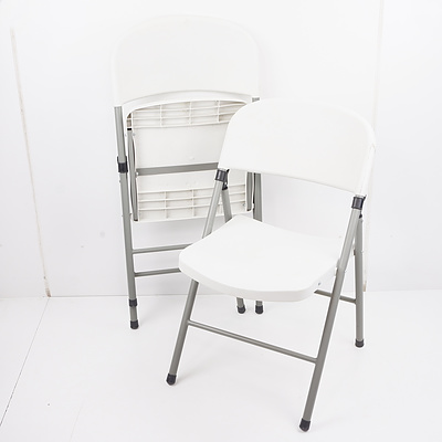 Two Folding White Plastic Folding Chairs