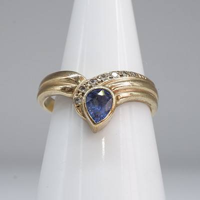 9ct Yellow Gold Ring with Pear Shaped Tanzanite and Eight Round Brilliant Cut Diamonds