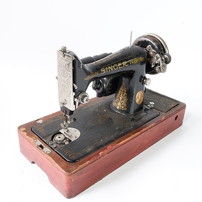 A British Manufactured Singer Sewing Machine on Wooden Base