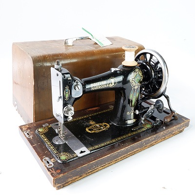 A British Manufactured Harrods Brand Sewing Machine in Wooden Carry Case