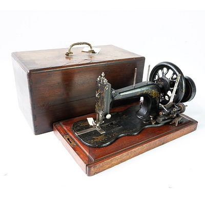 A Metal Sewing Machine on Wooden Stand