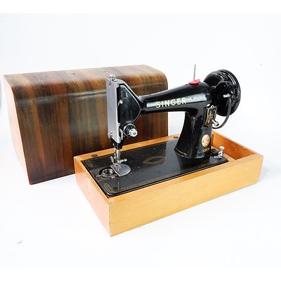 A Singer Sewing Machine on Wooden Stand