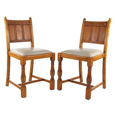 Four English Oak and Leather Upholstered Dining Chairs in the Tudor Style Circa 1930s