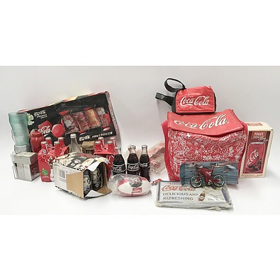 CocaCola Memorabilia including: Glass Bottles, Cans, Cooler Bags, A Puzzle, Models and More