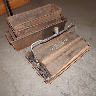 Four Antique Loaf Tins and an Early Bissell's Carpet Sweeper Head